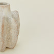 Detailed view of tall brutalist candle holder
