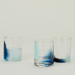 Three Blown Glass Tumblers in Sky and Peacock, filled with ice water.