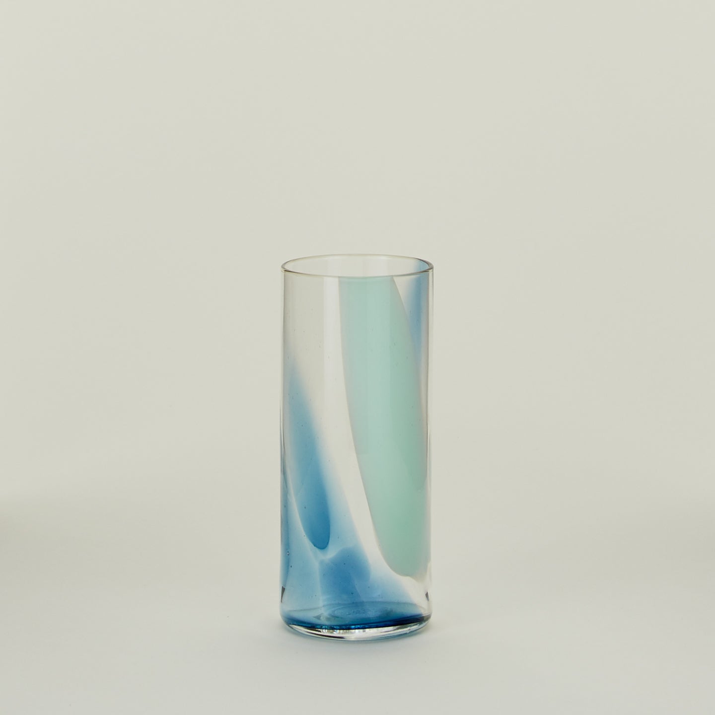 Blown Glass Highball with sky and peacock swirl pattern.
