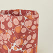 Detail of marbled hexagon wastebasket in warm tones.
