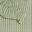 Close up view of Dove and Donkey hopsack tablecloth in leaf
