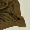 Close up view of linen tea towel with olives