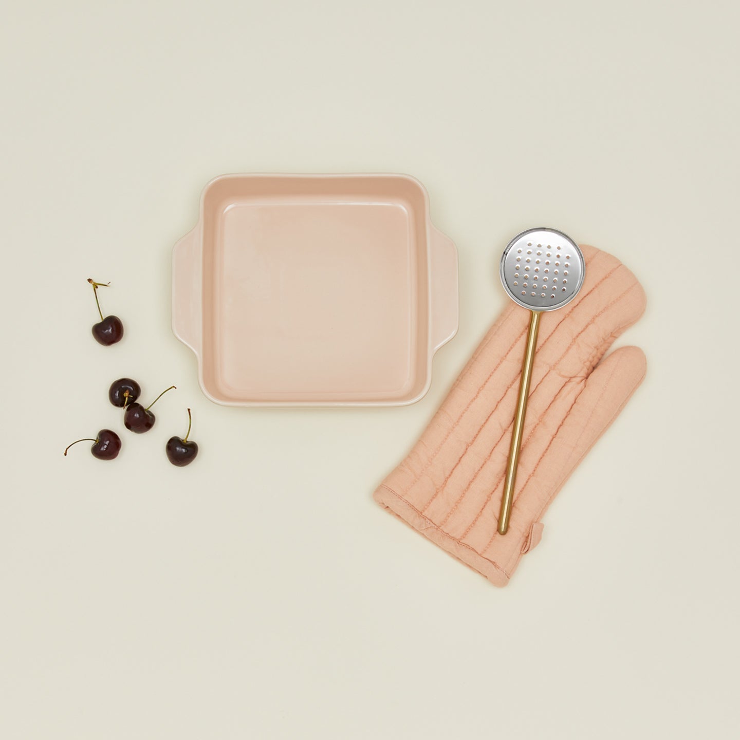 8" x 8" in essential bakeware in blush with cherries, spoon, and oven mit