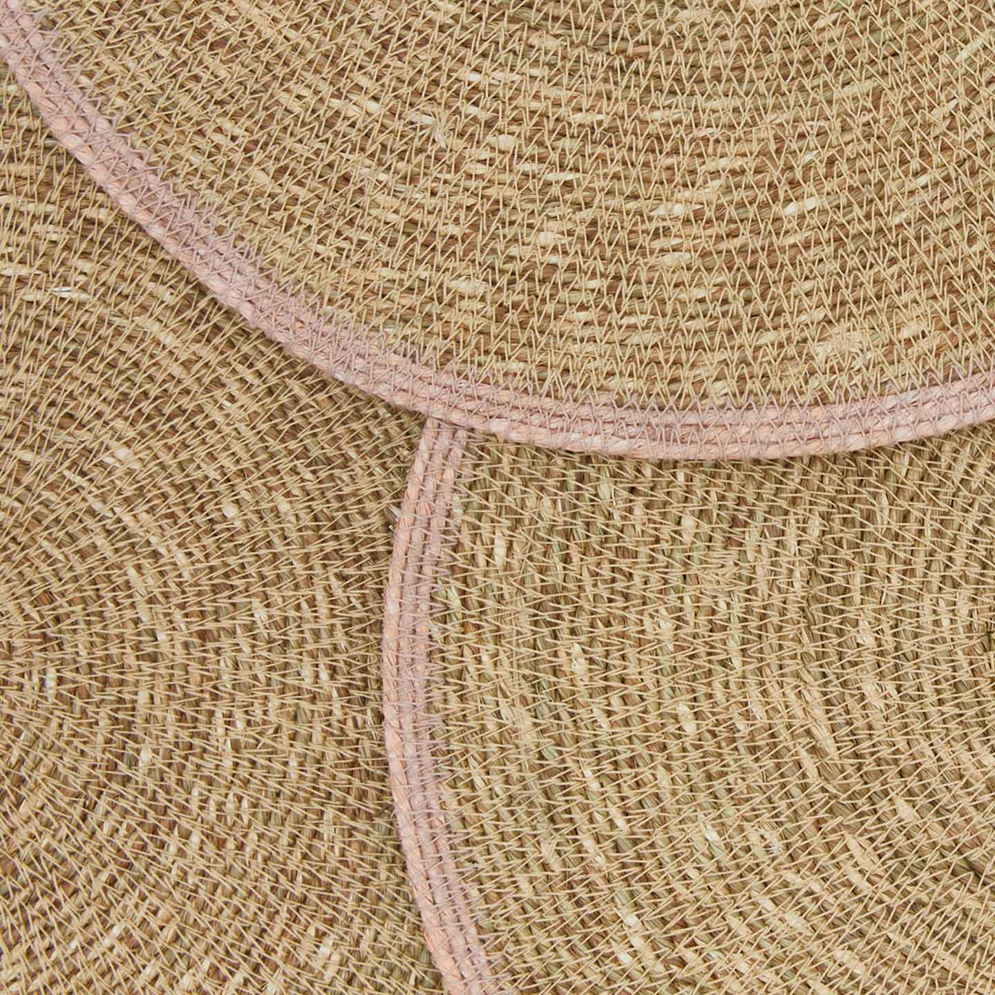 Close up view of essential woven placemats in blush.