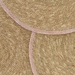 Close up view of essential woven placemats in blush.