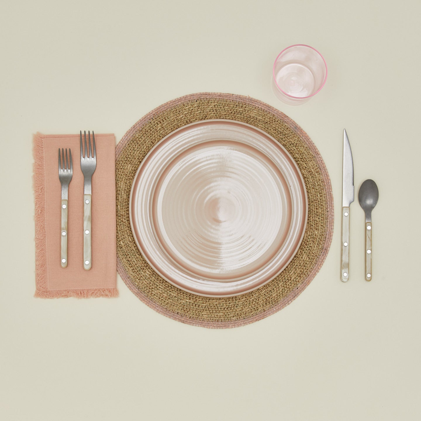 Essential Woven Placemat in blush with place setting.