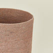 Close up view of essential woven wastebasket in blush