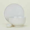 Group of Essential serving pieces in Bone including bowl, platter and extra small bowl.