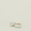 Two Essential Extra Small Bowls in Bone filled with pistachios.