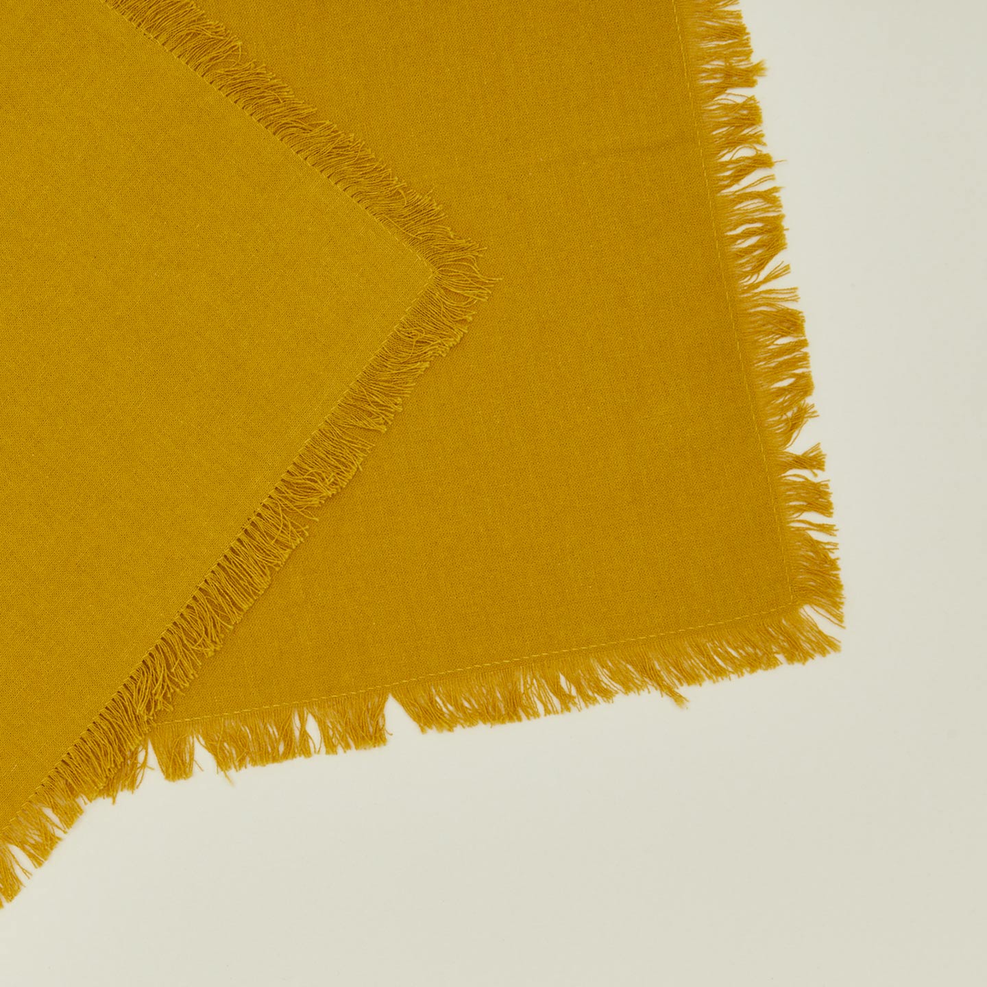 Close up view of essential cocktail napkin in mustard