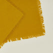 Close up view of essential cocktail napkin in mustard
