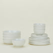 Set of bone white Essential dinnerware including Large Bowls, Low Bowls, Salad Plates and Dinner Plates.