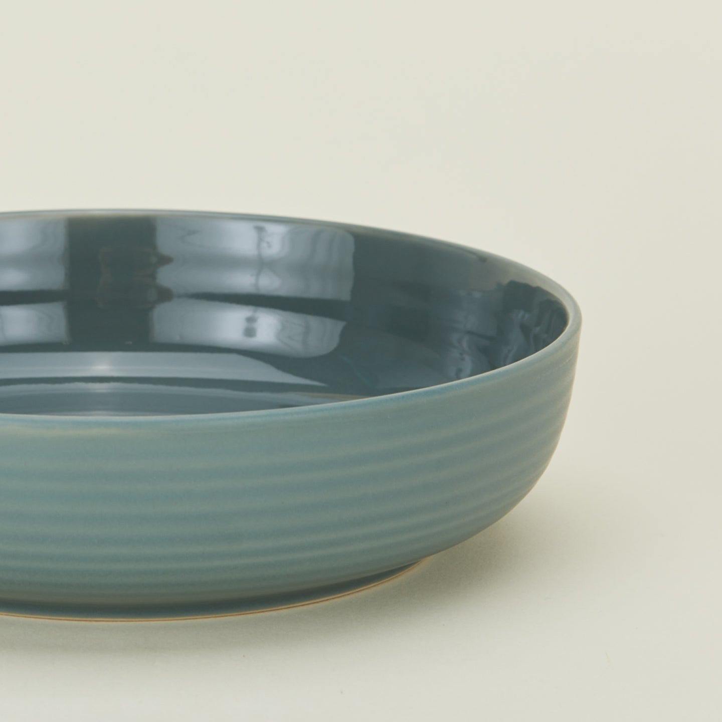 Close up view of essential dinnerware low bowl in peacock