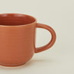 Close up view of essential dinnerware mug in terracotta