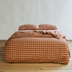 Essential Gingham Duvet - Blush/Terracotta on bed with matching pillow cases