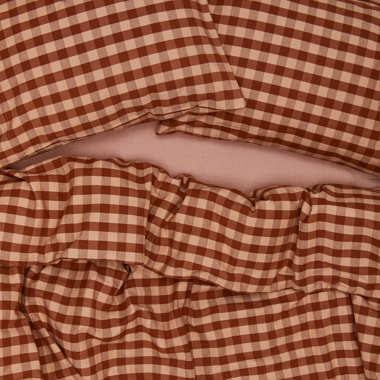 Essential Gingham Duvet - Blush/Terracotta on bed with matching pillow cases