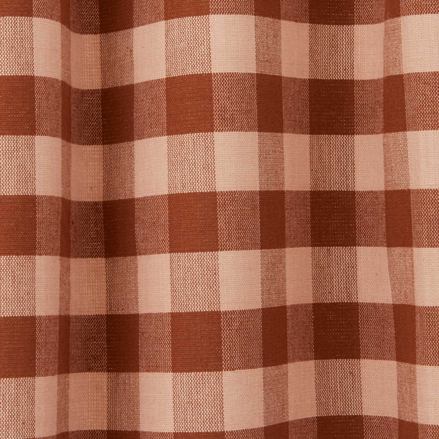 Close up view of gingham shower curtain in blush/terracotta