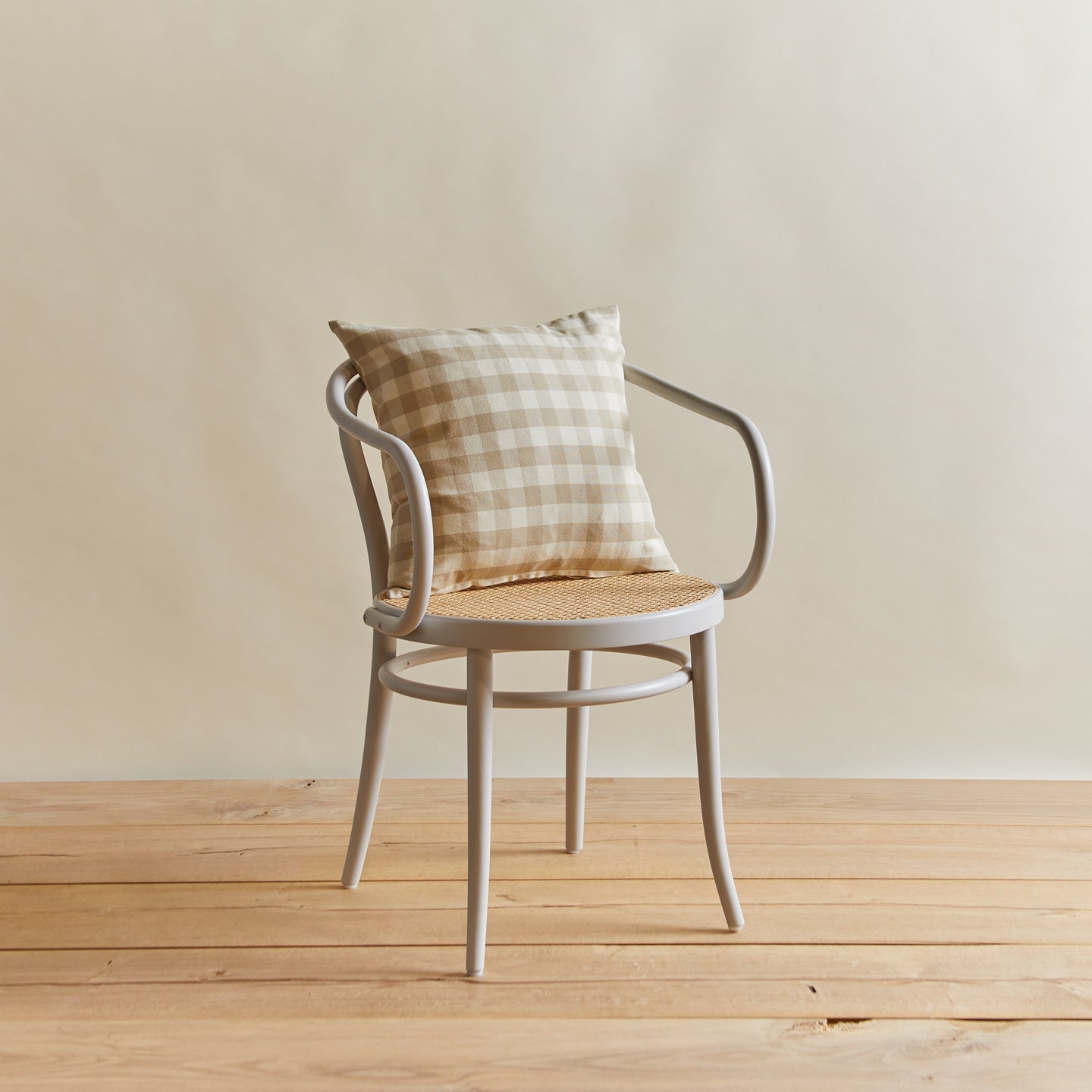 Essential gingham pillow in ivory/flax on chair