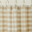 Gingham shower curtain in ivory/flax on gold curtain hooks