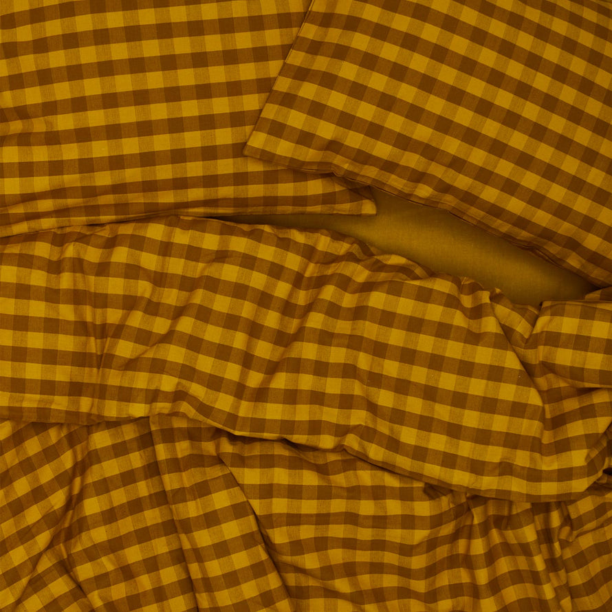 Essential Gingham Duvet - Mustard/Bronze on bed with matching pillow cases
