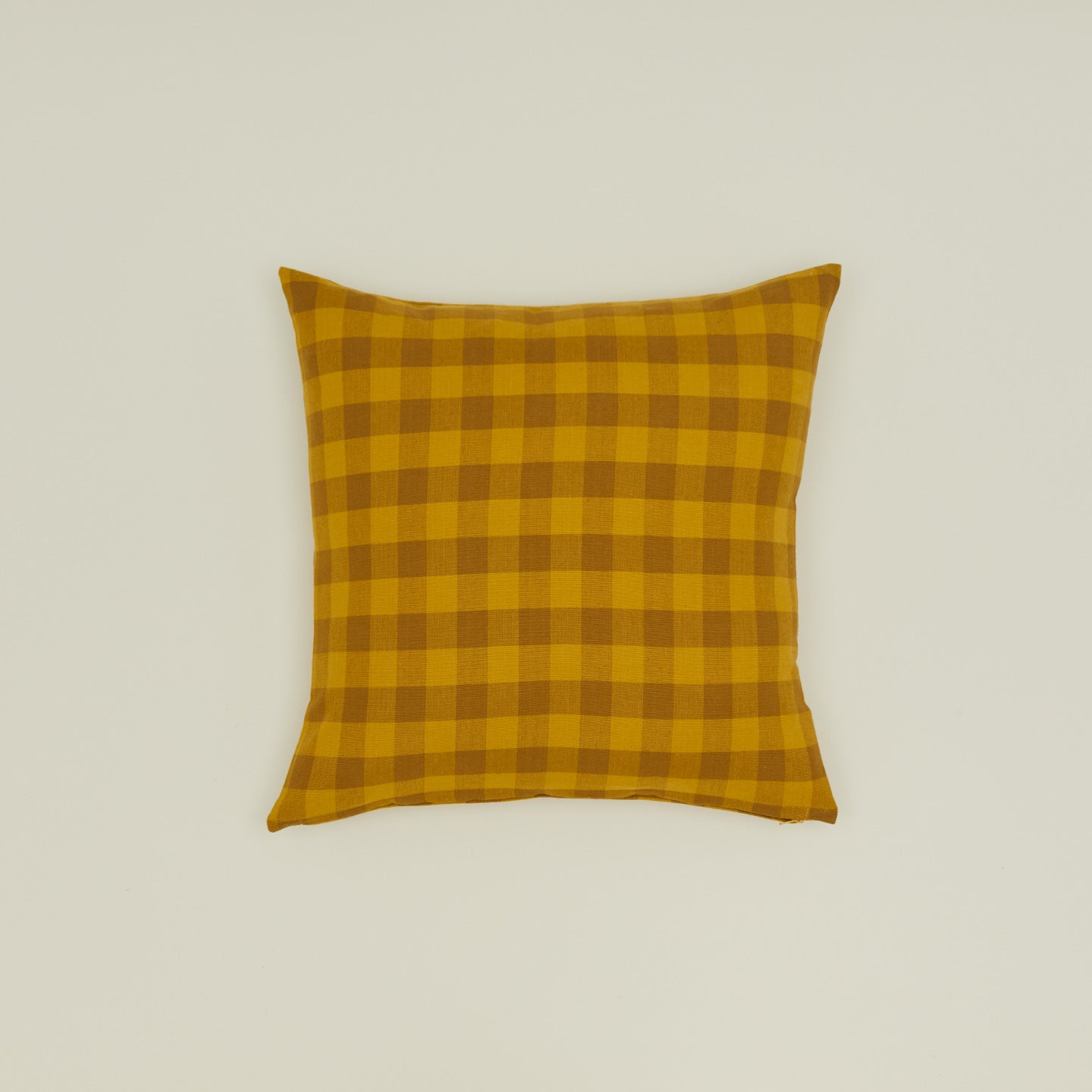 Gingham square pillow in mustard/bronze