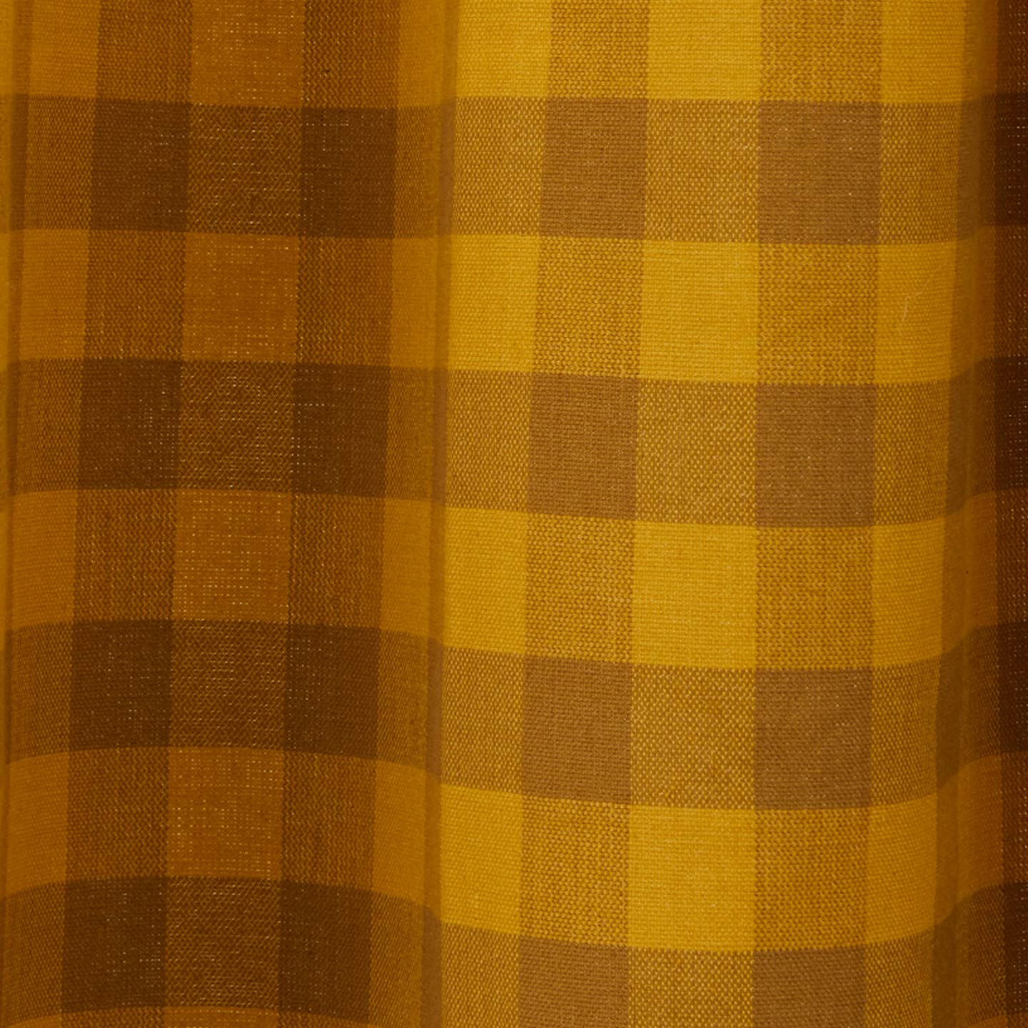 Close up view of gingham shower curtain in mustard/bronze