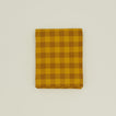 Gingham shower curtain in mustard/bronze