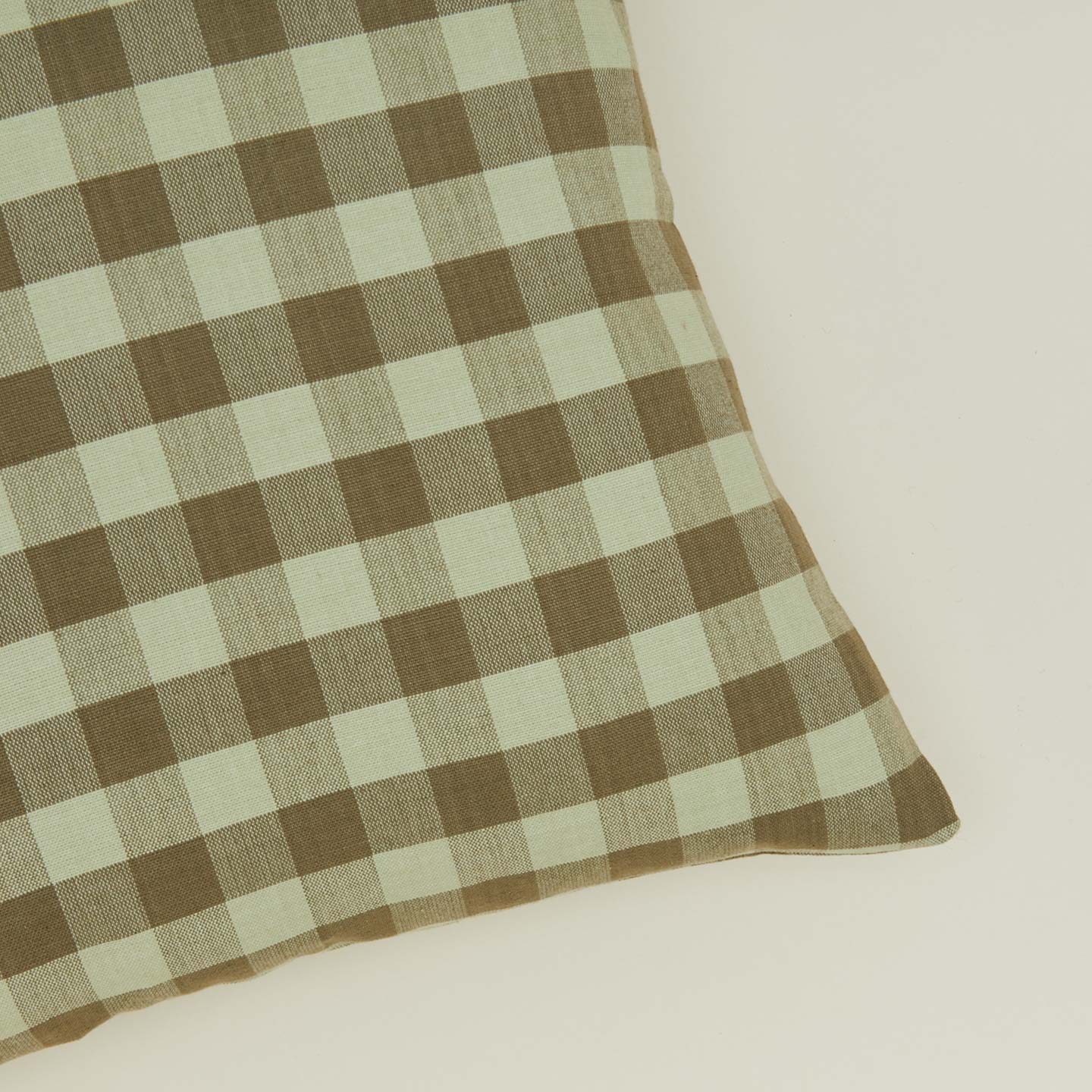 Close up view of gingham square pillow in sage/olive