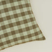 Close up view of gingham square pillow in sage/olive