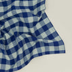 Close up view of Essential Gingham napkin in sky/blue