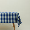 Essential Gingham tablecloth in sky/blue on a table.