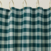 Gingham shower curtain in sky/peacock on gold curtain hooks