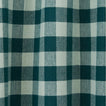 Close up view of gingham shower curtain in sky/peacock