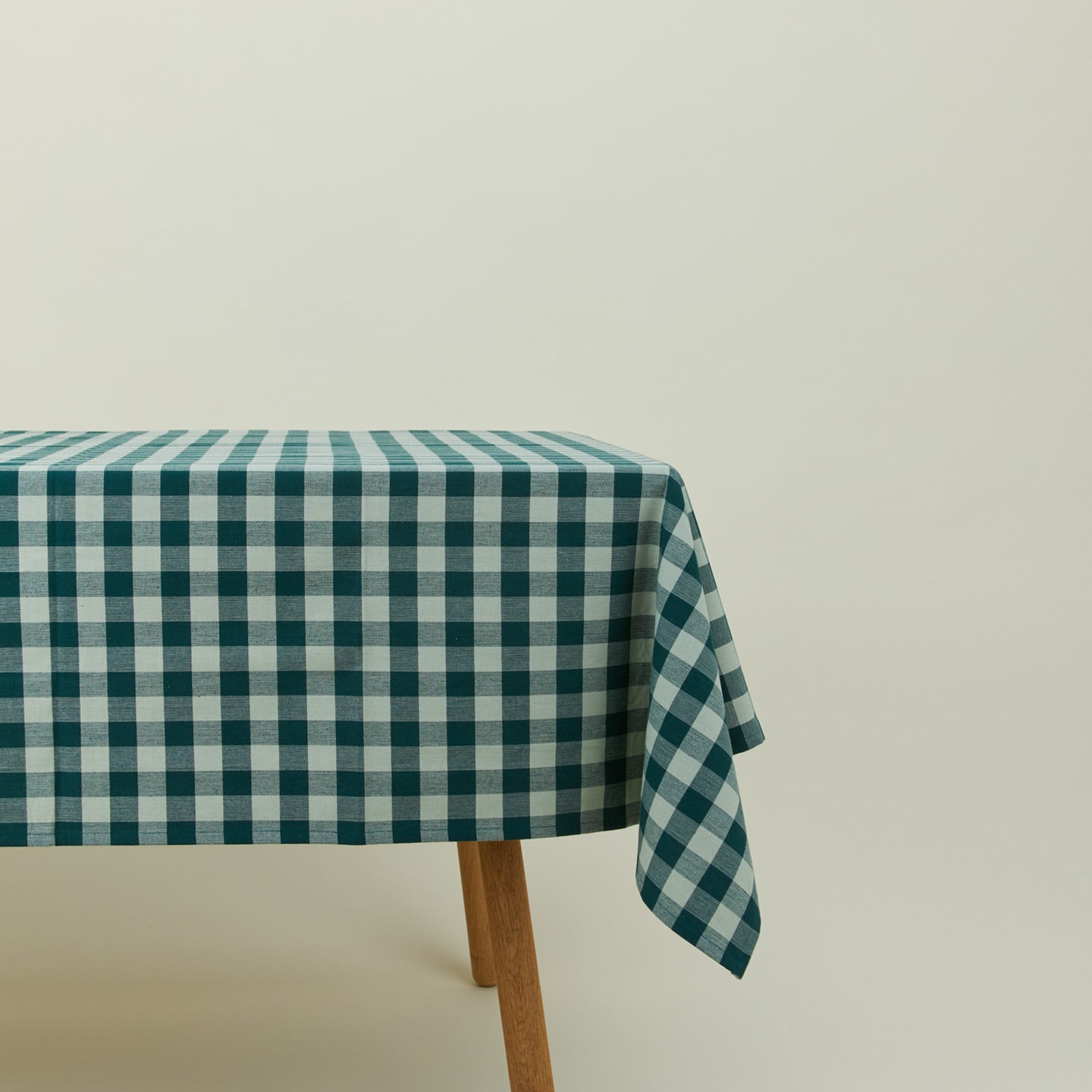 Essential Gingham tablecloth in sky/peacock on a table.