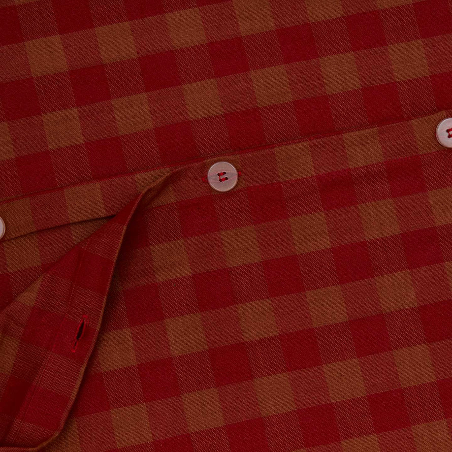 Close up view of essential gingham duvet cover in terracotta/red