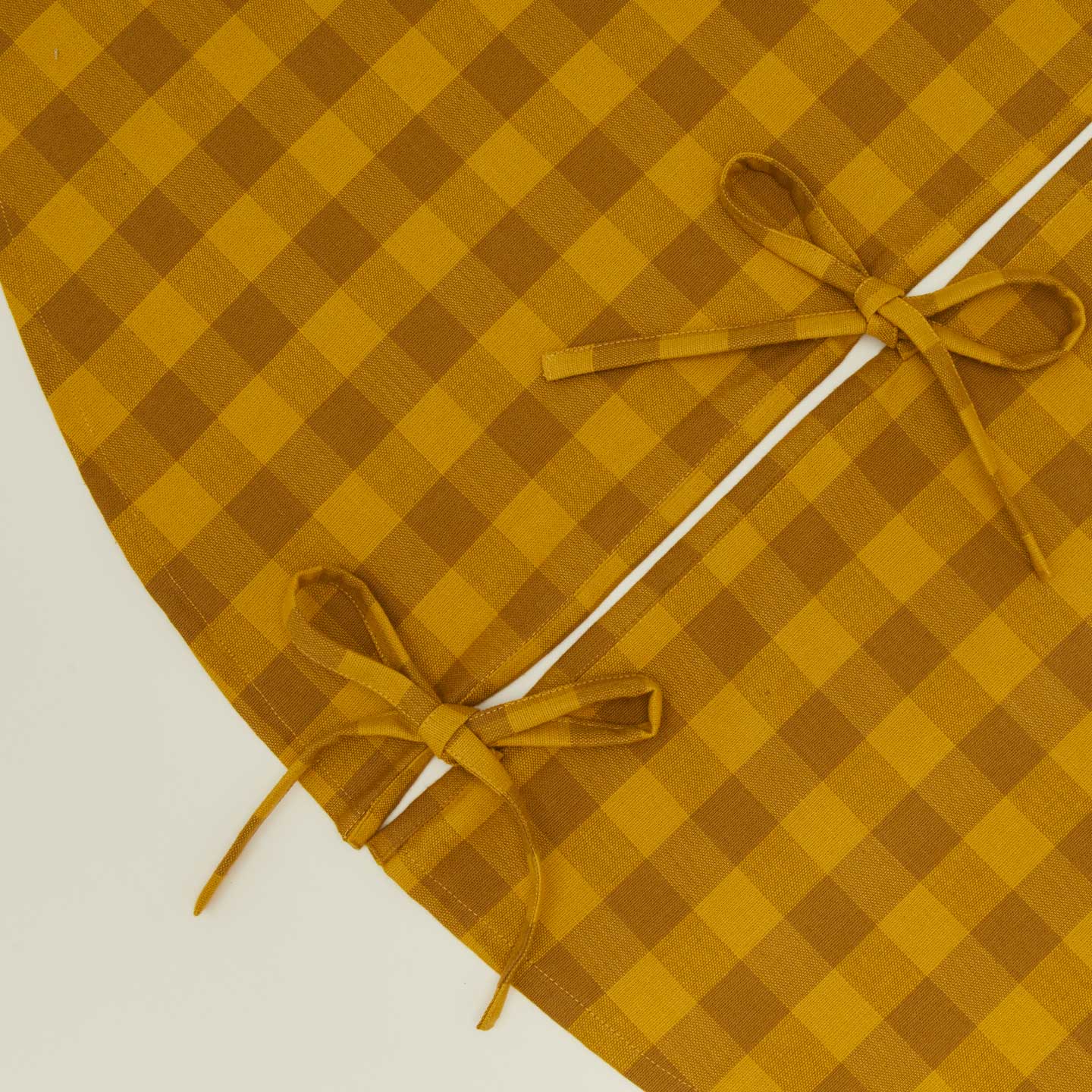 Detailed view of Essential GIngham Tree Skirt - Mustard/Bronze