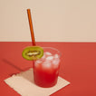 Essential Glass Straw in glass with drink and kiwi.
