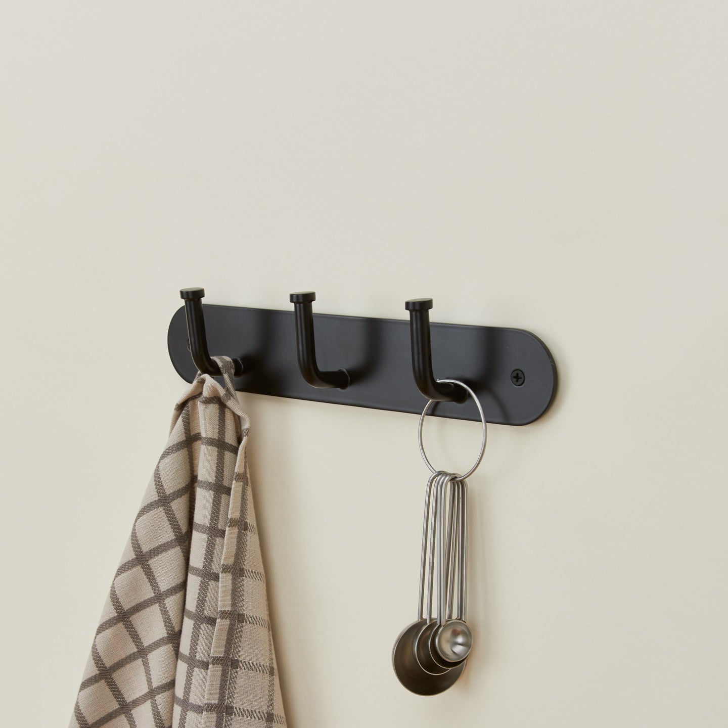 Essential hook rack in black with kitchen towel and measuring spoons
