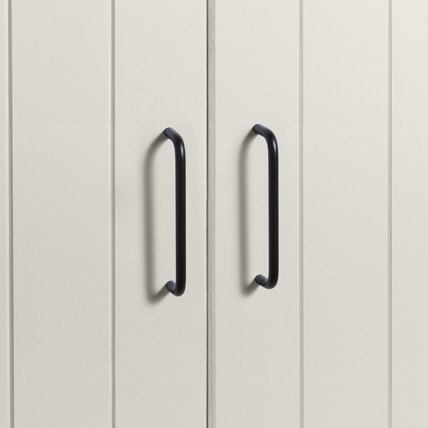 Large black pulls on white doors