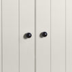 Small black essential sphere knobs on white doors