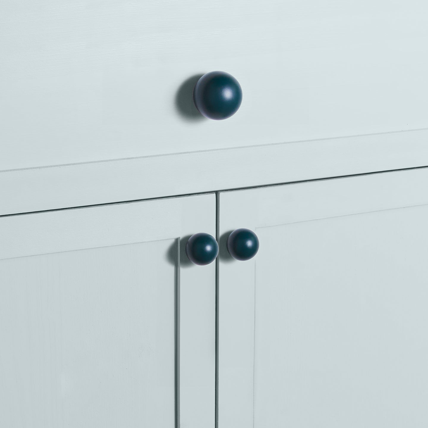 Large and small peacock essential sphere knobs on drawers and cabinets