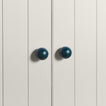 Large peacock essential sphere knobs on white doors