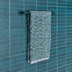 Essential towel bar in Dark Peacock with Space Dye terry hand towel in Peacock on tiled wall.