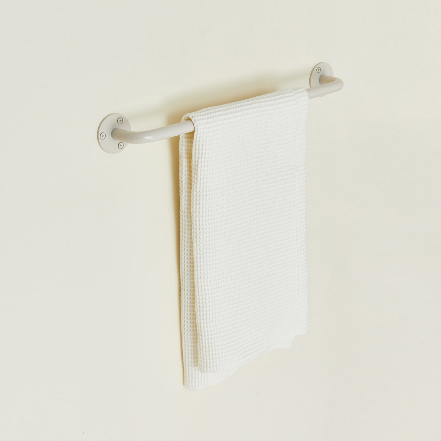 Small towel bar in Ivory with waffle dish towel.