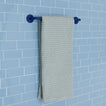 Essential towel bar in klein blue on a tile background.