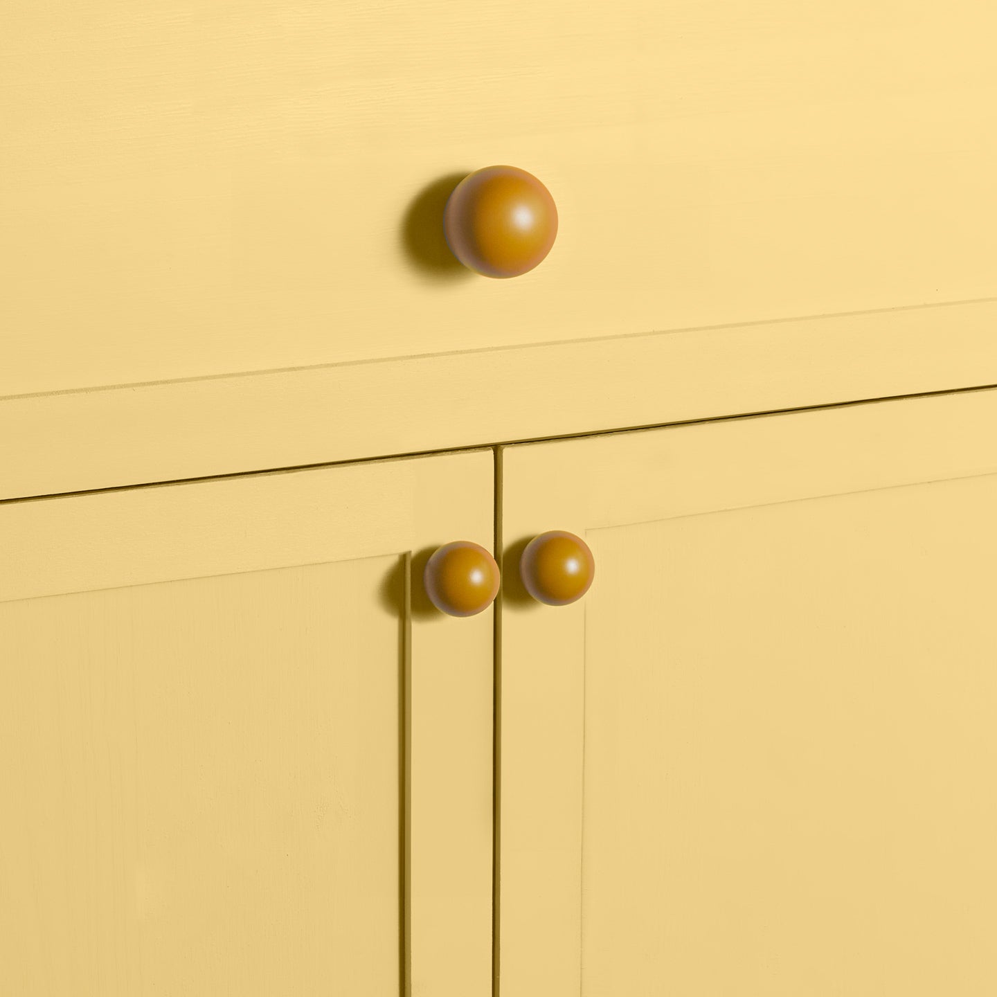 Large and small mustard essential sphere knobs on drawers and cabinets