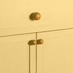 Large and small mustard essential sphere knobs on drawers and cabinets