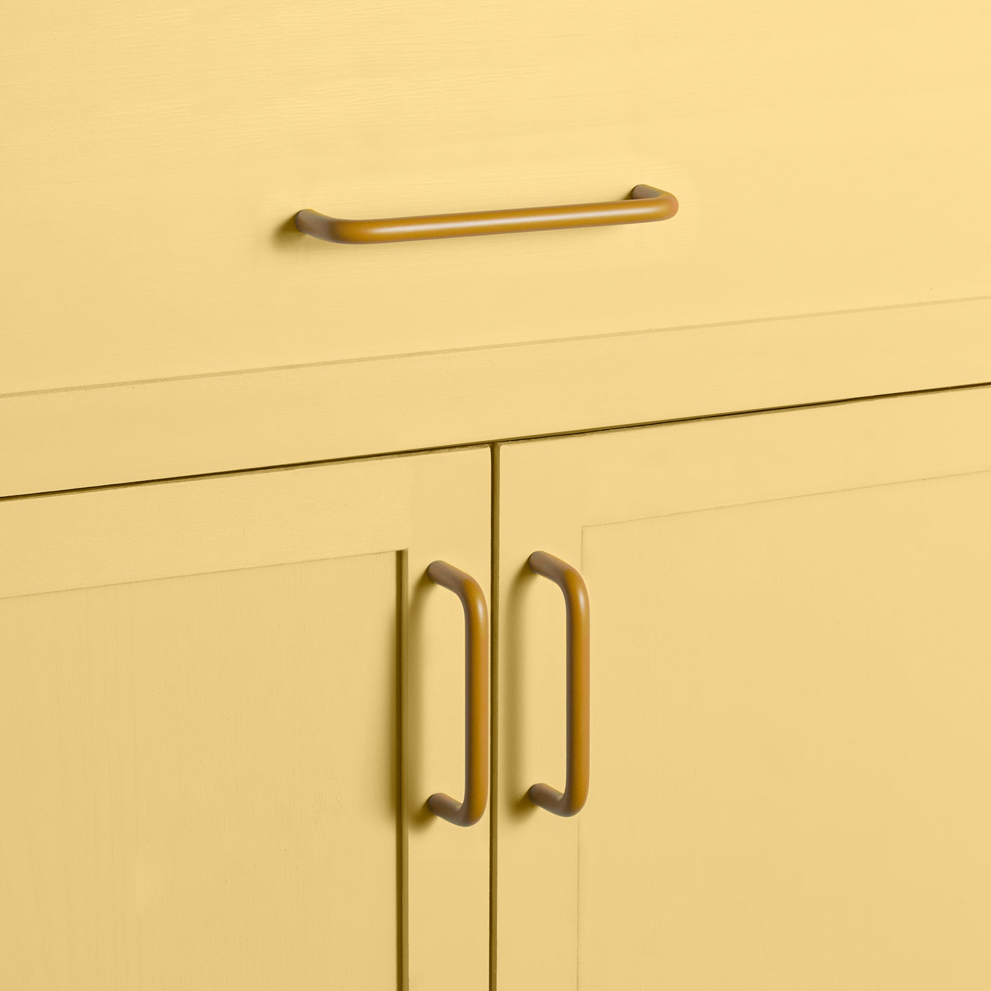 Large and small mustard pulls on drawers and cabinets