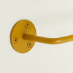 Close up of toilet paper holder in Mustard.