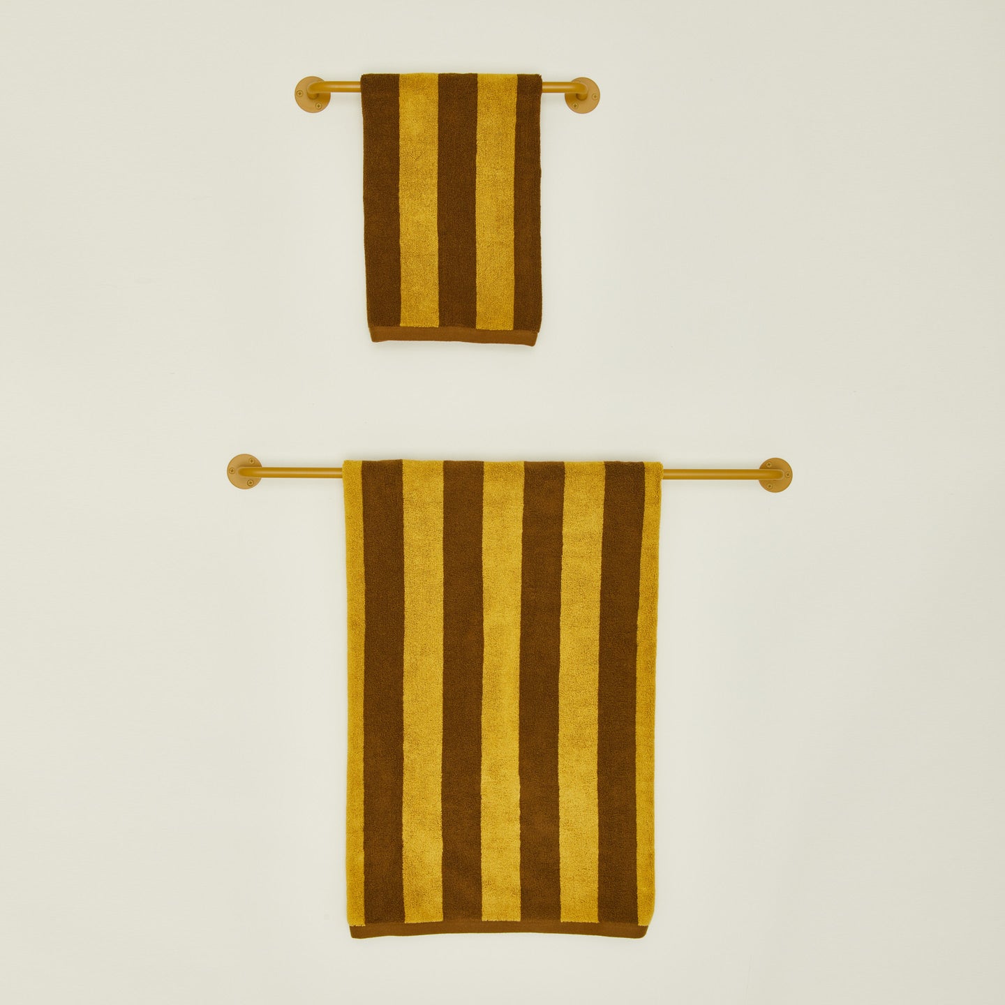 Small and large towel bars in Mustard with striped towels.